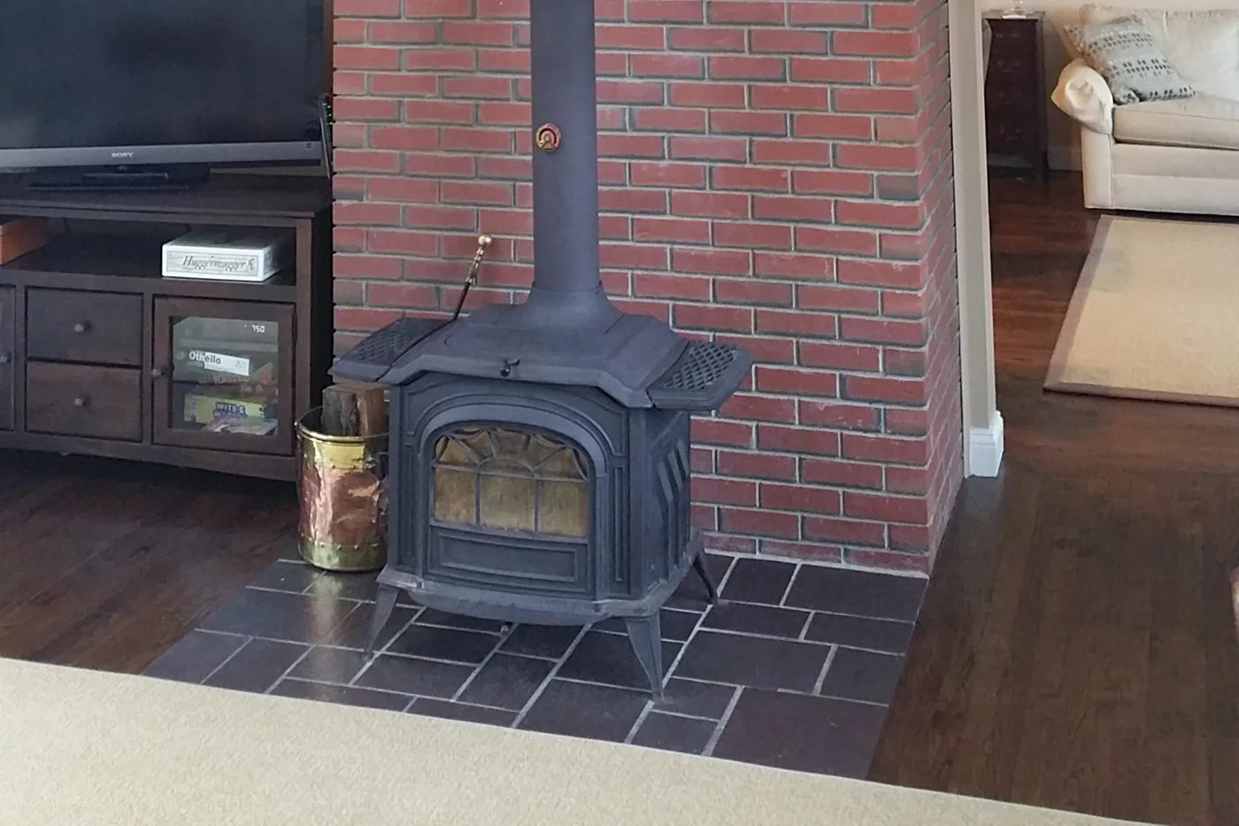 Before — dated red brick wood stove wall