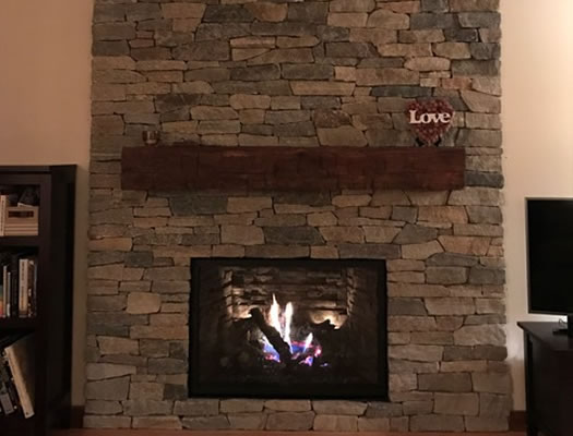 Stone veneer fireplace after