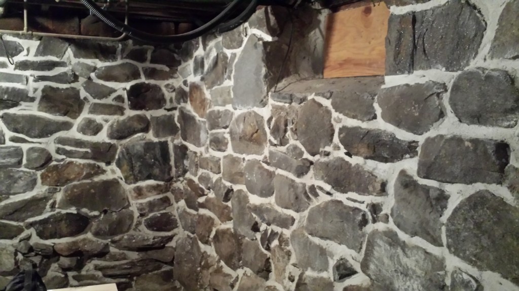 finished stone foundation repointing project brightening the basement