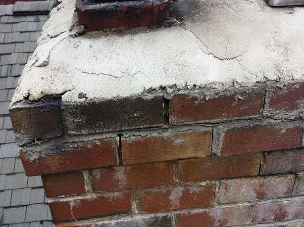 Water damaged brick chimney with failed masonry repairs